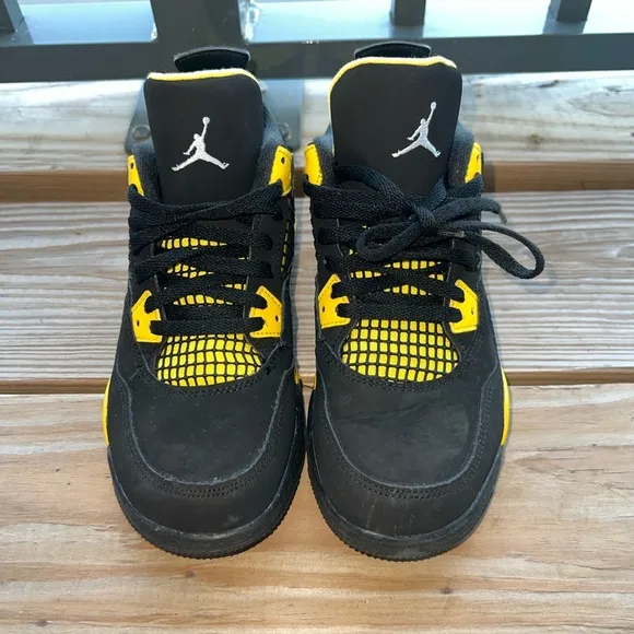 Air Jordan Retro 4 “Thunder” Black and Yellow Sneakers with Iconic Jumpman Logo