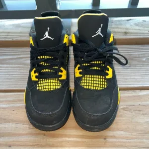 Air Jordan Retro 4 “Thunder” Black and Yellow Sneakers with Iconic Jumpman Logo
