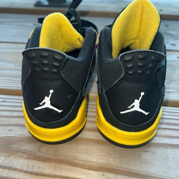 Air Jordan Retro 4 “Thunder” Black and Yellow Sneakers with Iconic Jumpman Logo