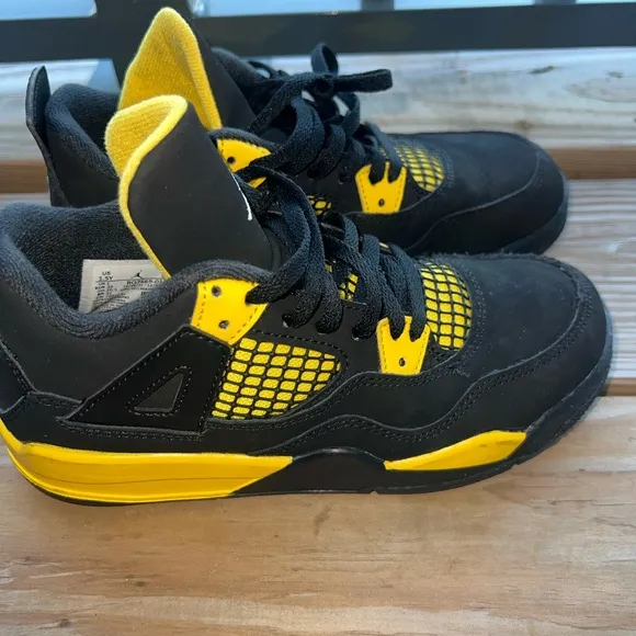 Air Jordan Retro 4 “Thunder” Black and Yellow Sneakers with Iconic Jumpman Logo