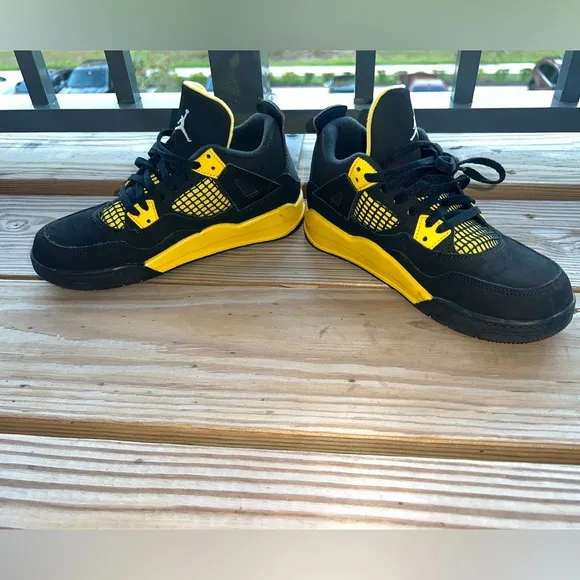 Air Jordan Retro 4 “Thunder” Black and Yellow Sneakers with Iconic Jumpman Logo