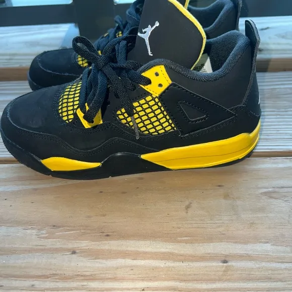 Air Jordan Retro 4 “Thunder” Black and Yellow Sneakers with Iconic Jumpman Logo