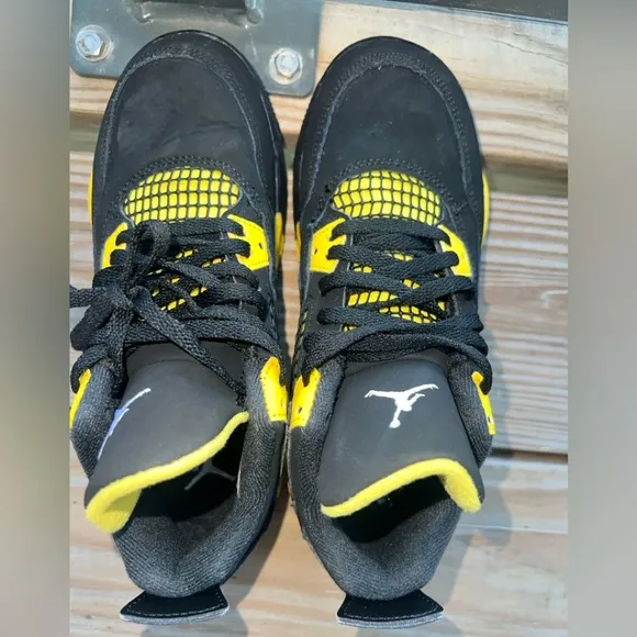 Air Jordan Retro 4 “Thunder” Black and Yellow Sneakers with Iconic Jumpman Logo