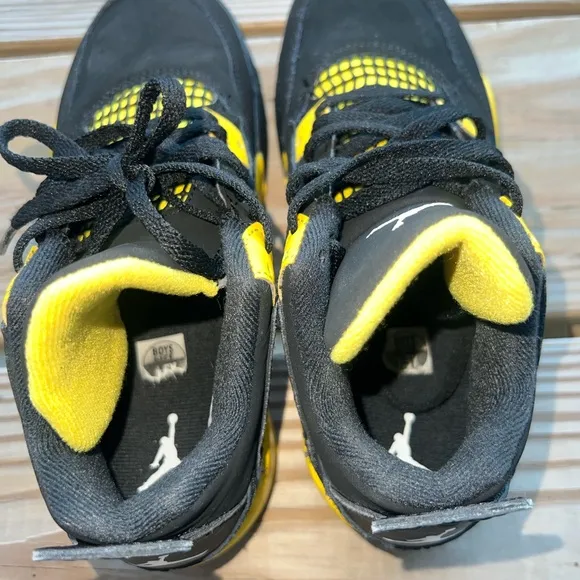 Air Jordan Retro 4 “Thunder” Black and Yellow Sneakers with Iconic Jumpman Logo
