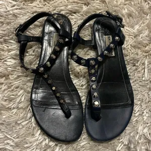 Balenciaga leather sandals with metal studs on the straps.